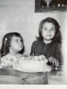 black and white photo of two young girls with birthday cake